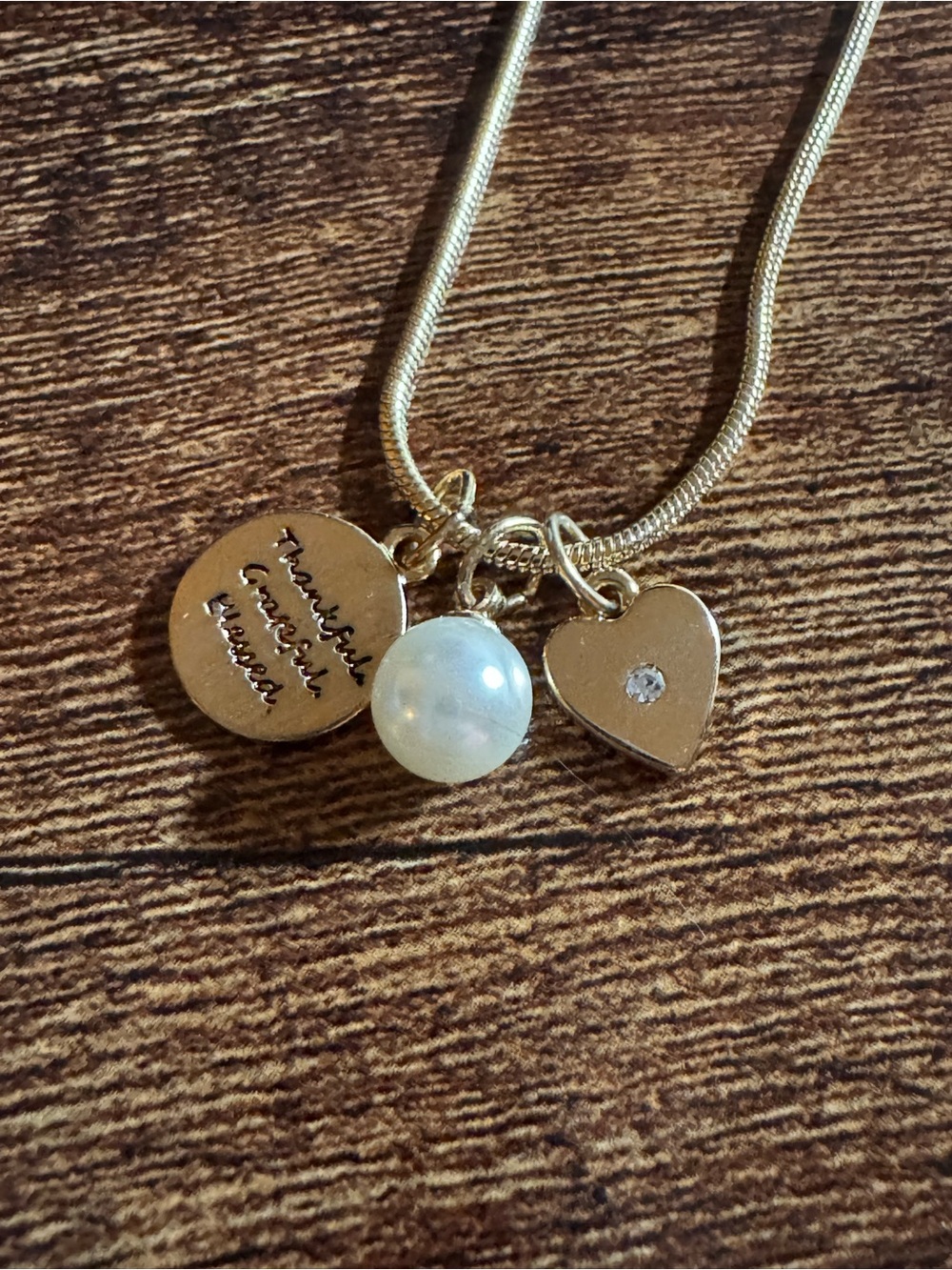 Women’s Gold Tone Pendant Necklace with 3 mini charms.